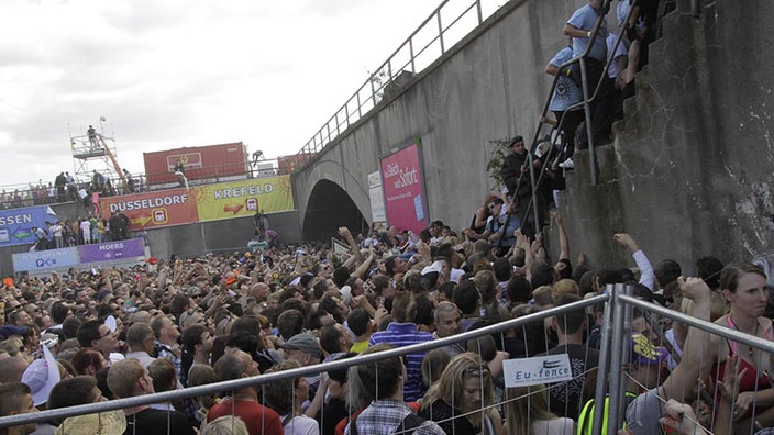 Loveparade-Besucher versuchen, Treppe zu erreichen