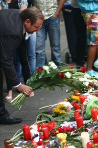 Duisburgs Bürgermeister Adolf Sauerland legt Blumen an der Trauerstelle für die Opfer der Loveparade nieder