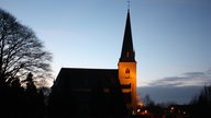 Angeleuchtete Kirche in der Dämmerung