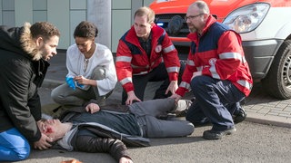 Auf der Flucht vor Matteo (Mike Adler, r.), wird Dennis (Elias Kaßner, liegend.) von einem Rettungswagen angefahren