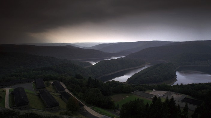 Luftaufnahme der Burg Vogelsang, im Hintergrund ist ein See erkennbar.