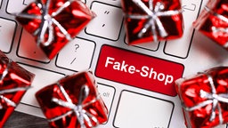 Geschenke auf Computertastatur und Computertaste mit der Aufschrift Fake-Shop