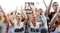 2 Mädchen tragen T-Shirts jeweils mit der Aufschrift John und Ossi was nebeneinander den Bandnamen Johnossi ergibt