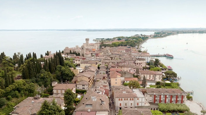 Blick auf die Stadt Sirmione von oben, die sich über eine schmale Landzunge erstreckt