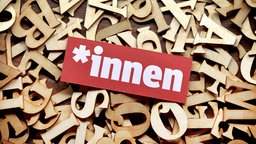 Gendersternchen und Schriftzug "Innen" auf Buchstaben. 