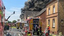 Löchfahrzeige vor einem Haus in Sankt Augustin mit riesiger Rauchwolke