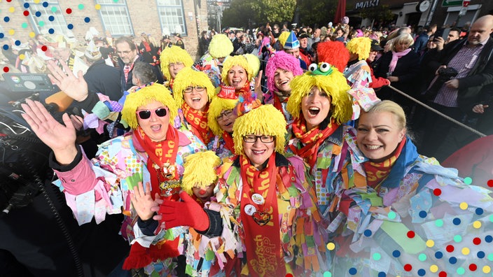 Feierwütige feiern in Düsseldorf den Straßenkarneval, Konfetti.