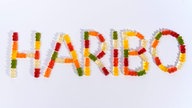 Bunte Gummibärchen bilden den Schriftzug Haribo 