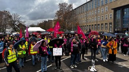 Mehrere Demonstranten mit Schildern und Fahnen