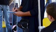 Junger Mann bei einer Fahrkartenkontrolle in einer Straßenbahn - Archivbild