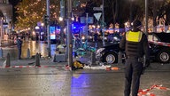 Polizist und Auto nach Unfall auf der Königsallee