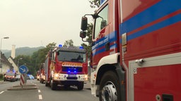 Die Feuerwehr ist vor einer Lagehalle im Einsatz.