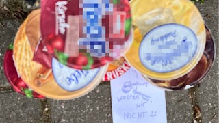 Ein Turm mit Joghurtbecher. Davor liegt ein Zettel mit der Auffschrift "Joghurt wollen wir nicht"