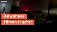 Aufgenommene Szenen zeigt wie eine Person über eine dunkle Straße läuft. Darüber die Schrift "Anwohner filmen Flucht!"