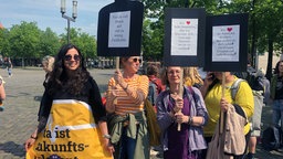 Demonstrierende Menschen mit Plakaten