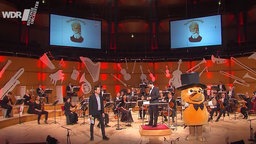 Die Maus steht mit dem WDR Sinfonieorchester auf der Bühne