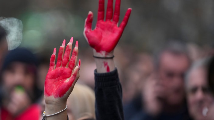 Frauen heben während einer Demonstration ihre rot bemalten Hände, die das Blut symbolisieren, einen Tag nach dem Angriff auf Studenten durch Schläger mit Baseballschlägern.