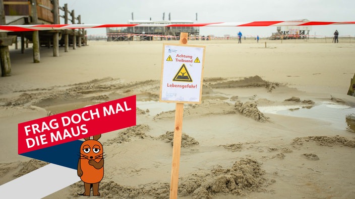 Am Strand von St. Peter-Ording ist Flatterband und ein Warnhinweis ("Achtung Treibsand - Lebensgefahr!") an einem abgesperrten Bereich zu sehen.