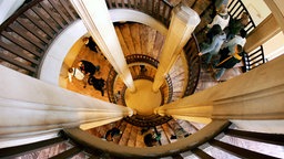 Besucher des Schweriner Schlosses gehen über die Wendeltreppe zu den Austellungsräumen des Schlossmuseums