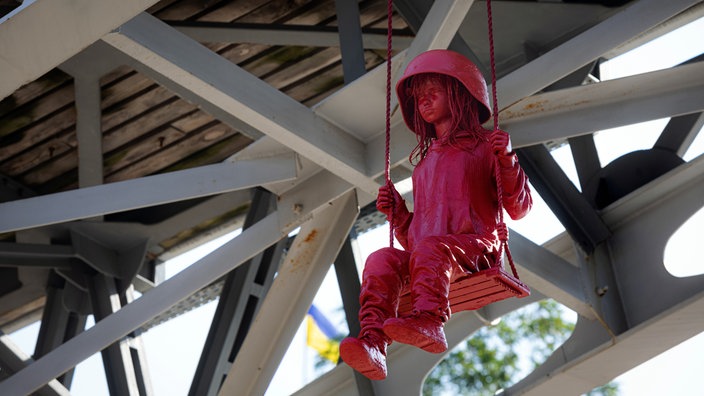 Sculpture of girl on swing by James Colomina in Kyiv