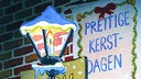 Comic-Zeichnung: Ein Schild mit der Aufschrift "Prettige Kerstdagen".