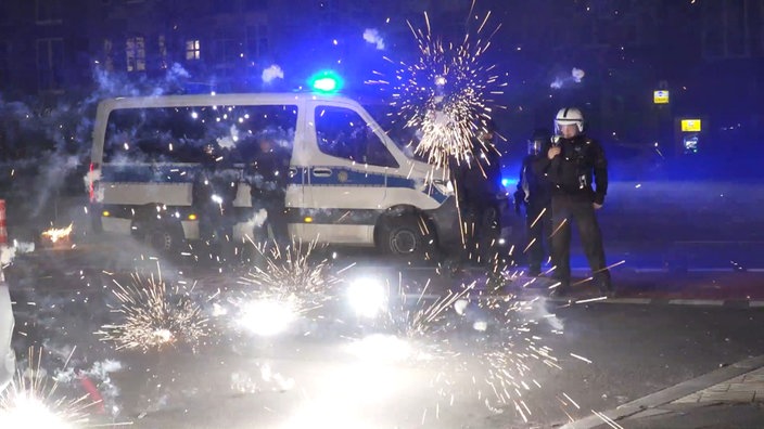 Beamte stehen hinter explodierendem Feuerwerk 