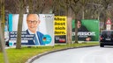 Wahlplakate zur Bundestagswahl 2025 an einer Straße.