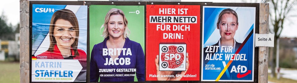 Plakatwand mit mehreren Wahl-Plakaten.