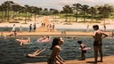 Symbolbild für die Garzweiler Seelandschaft einem Strand, schwimmenden Menschen und einem Steg auf dem Wasser.