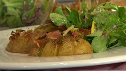 Kartoffeln in der Schale mit Feldsalat auf einem Teller angerichtet